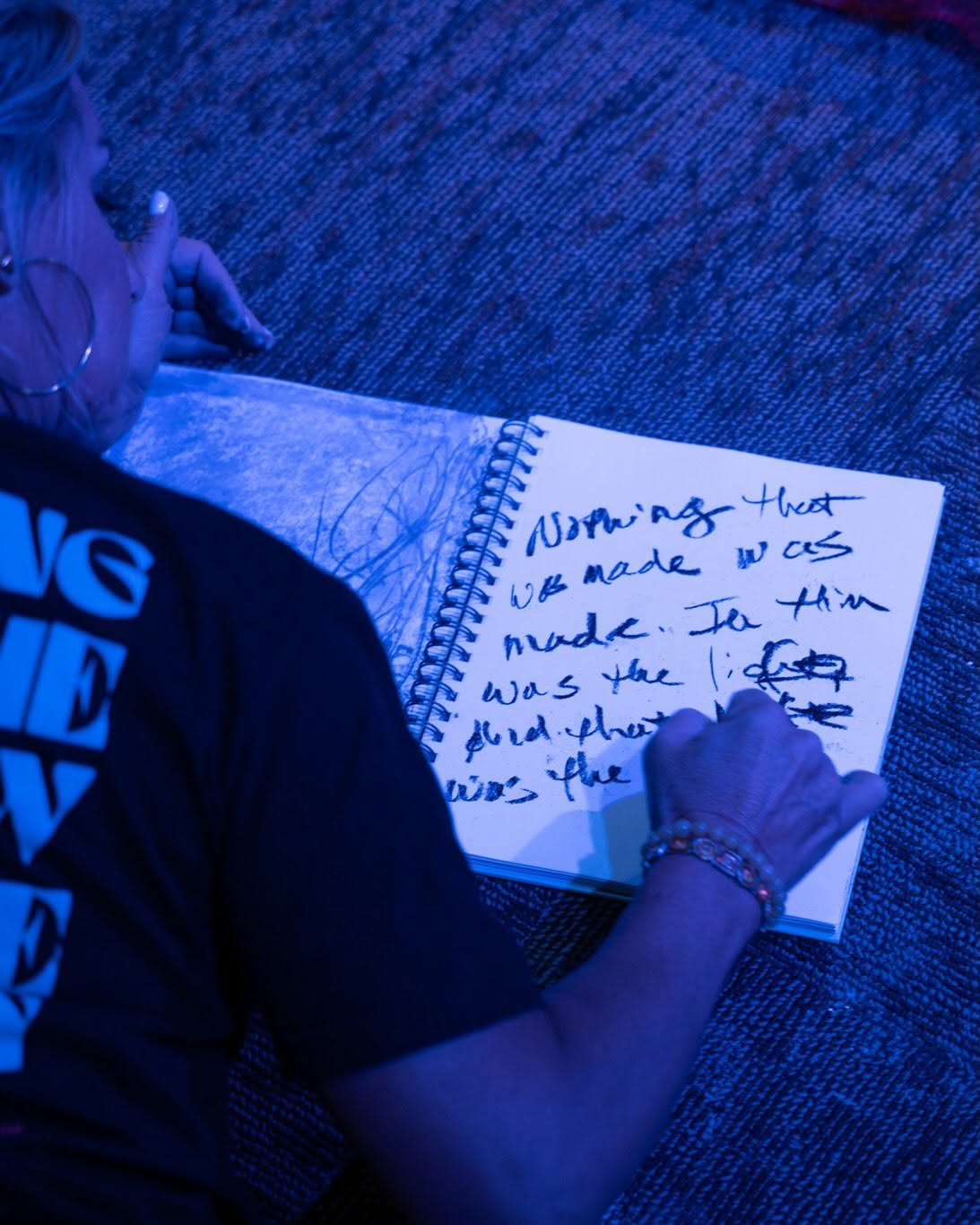 A participant writing and drawing in a creative journal